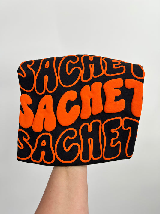 WAVY STACK Puff design  - orange PUFF on black - COMFORT COLORS™